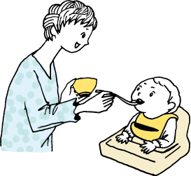 赤ちゃんに離乳食を食べさせる親
